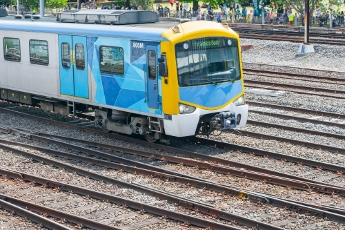 A commuter train running through a railway yard - Australian Stock Image