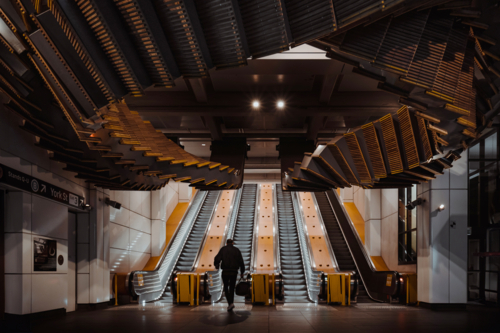 A commuter using the escalators at Wynyard Station - Australian Stock Image