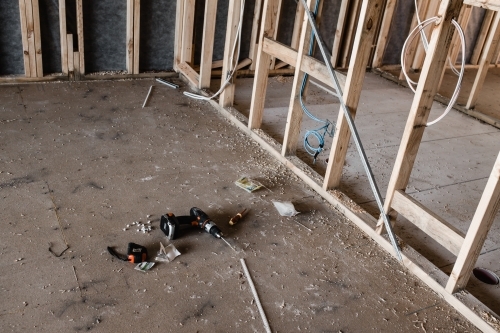A construction site of a house being built with focus on tools on the ground - Australian Stock Image