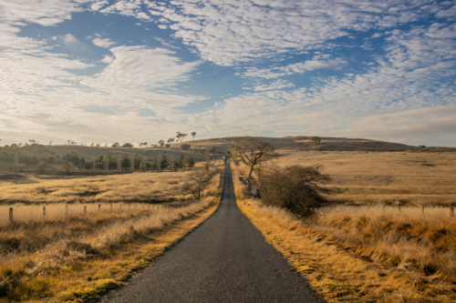 A country road on a winter's day under a cloudy sky - Australian Stock Image