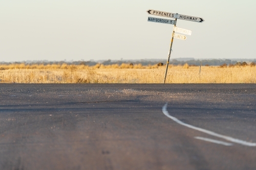 A crooked signpost on a roadside of a rural intersection - Australian Stock Image