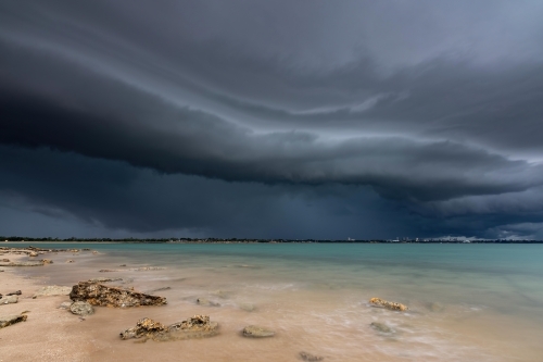 A dark shelf cloud approaches over the ocean - Australian Stock Image