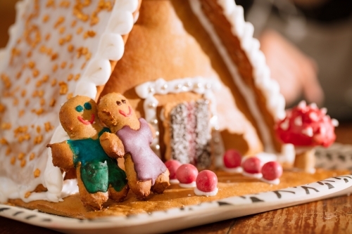 A decorated homemade gingerbread house with figurines