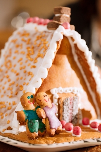 A decorated homemade gingerbread house with figurines - Australian Stock Image
