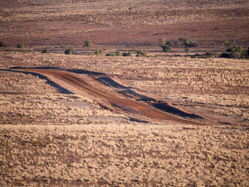 A dirt road running through farmland in outback New South Wales - Australian Stock Image
