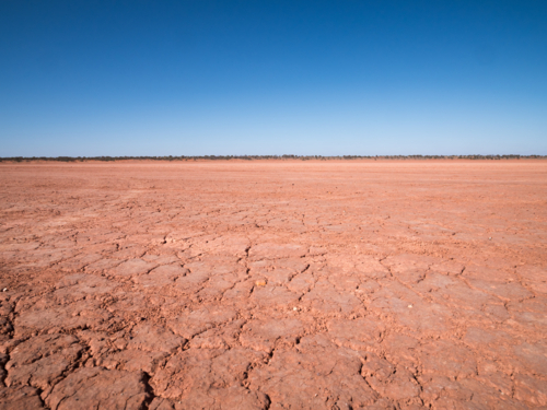 A dry mudplain and a blue sky in remote north-west New South Wales - Australian Stock Image