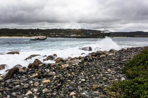 A fishing boat enters Grassy Harbour on King Island - Australian Stock Image