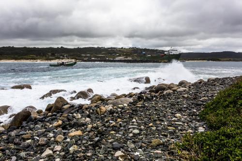 A fishing boat enters Grassy Harbour on King Island