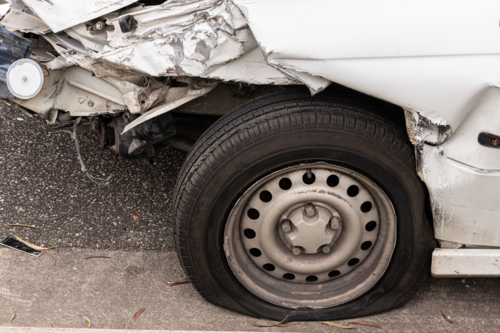 a flat tyre wheel after a bad car rash accident - Australian Stock Image