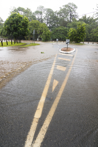 A flooded suburban street in suburban Brisbane during a major rain event - Australian Stock Image