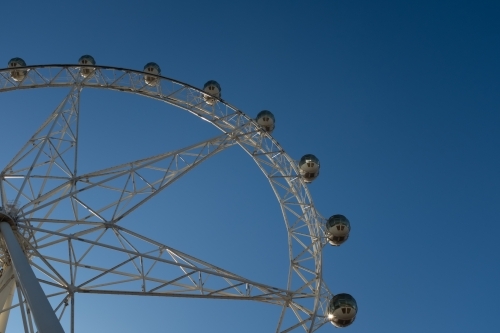A generic large ferris wheel with gondolas to enjoy the view - Australian Stock Image