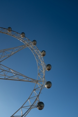 A generic large ferris wheel with gondolas to enjoy the view - Australian Stock Image