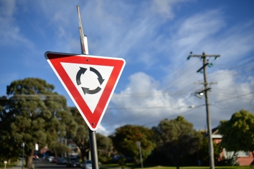 A give way at the roundabout street sign in the sun - Australian Stock Image