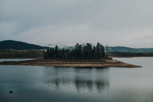 a glassy lake during draught on a winter day during a cloudy and fog weather - Australian Stock Image