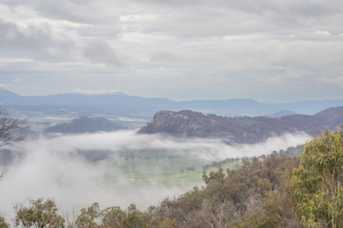 A granite monolith on a misty morning in the country - Australian Stock Image