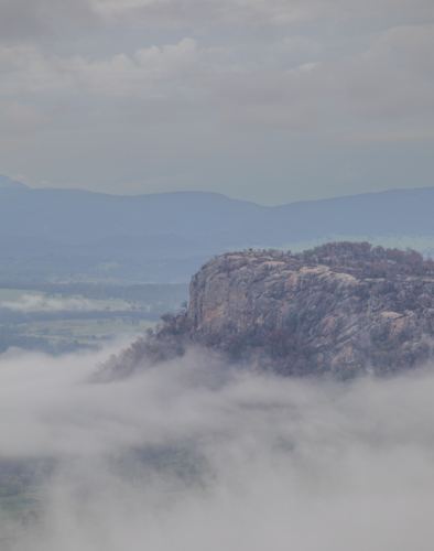 A granite monolith on a misty morning in the country - Australian Stock Image