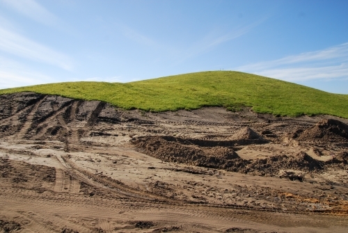 A grassy piece of land that has been excavated during construction works