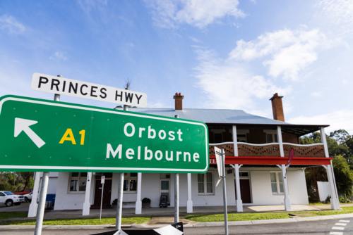 A green road sign directing towards Orbost and Melbourne along the Princes Highway - Australian Stock Image