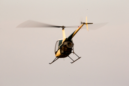 A helicopter in mid-flight in sky with motion blur shake - Australian Stock Image