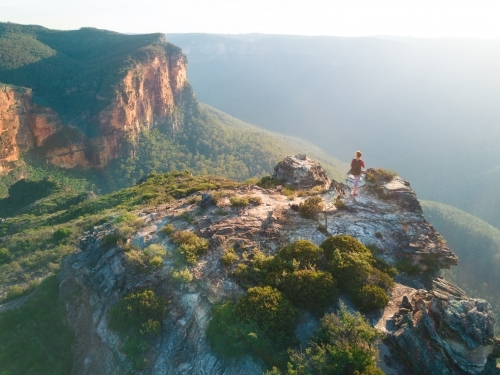 A hiker exploring the Govetts Gorge area of Blue Mountains, standing on a precipice