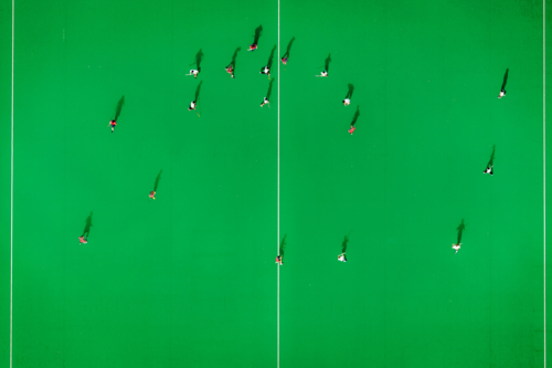 A hockey game on the green court at Kyeemagh. - Australian Stock Image