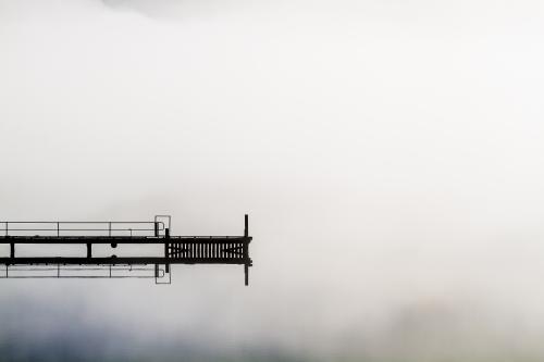 A jetty floats into the middle of a misty Huon River