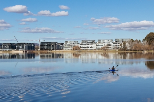 A kayaker glides across Lake Burley Griffin in Canberra - Australian Stock Image