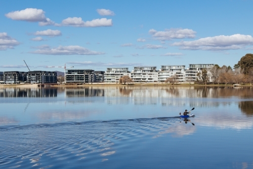 A kayaker glides across Lake Burley Griffin in Canberra