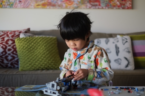 a kid building a Lego piece - Australian Stock Image