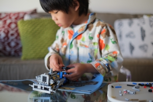 a kid building a Lego piece - Australian Stock Image