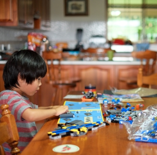 a kid building a Lego piece - Australian Stock Image