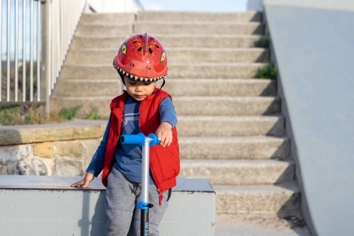 a kid with his scooter at a skate park - Australian Stock Image