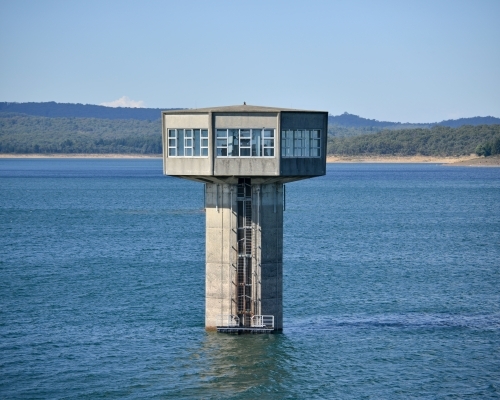 A large control tower in a freshwater reservoir