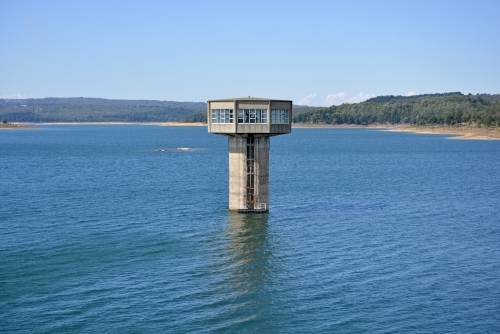 A large control tower in a freshwater reservoir
