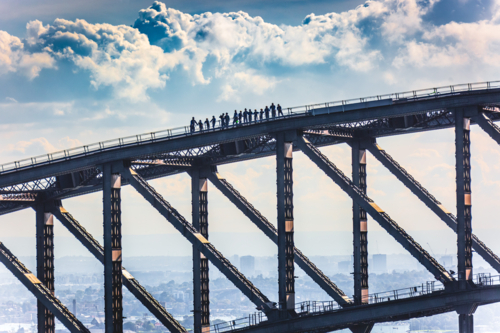 A line of climbers on the steel arch of the Harbour Bridge - Australian Stock Image