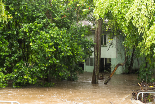 A low lying house adjacent to a creek in Ashgrove flooded underneath - Australian Stock Image