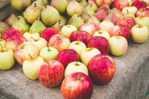 A market stall with red and yellow apples and green pears - Australian Stock Image