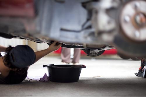 A mechanic services a vehicle. - Australian Stock Image