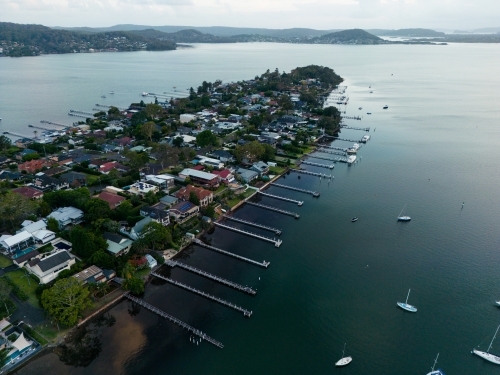 A narrow peninsula surrounded by homes with jetties in Gosford. - Australian Stock Image