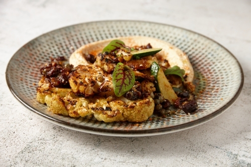 A plate of Mediterranean food - vegetables with hummus - Australian Stock Image