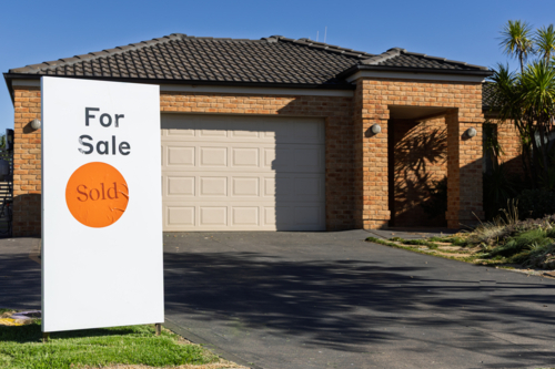 A real estate sign placed outside a house for sale, now sold - Australian Stock Image