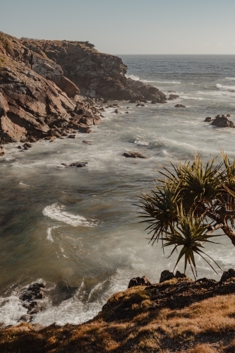 A rocky beach scene just after sunrise near Flynns Beach, Port Macquarie. - Australian Stock Image