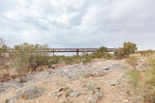 A rocky terrain with a bridge made of metal - Australian Stock Image