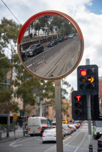 A round safety mirror for traffic and trams with a reflection - Australian Stock Image