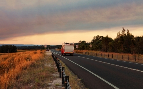 A  Rural Fire Service, fire and rescue vehicle responds urgently to a large out of control bushfire