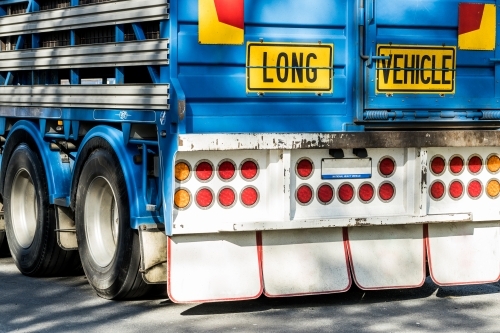 A sign reading 'Long Vehicle' on the back of a semi trailer road train used to transport animals - Australian Stock Image