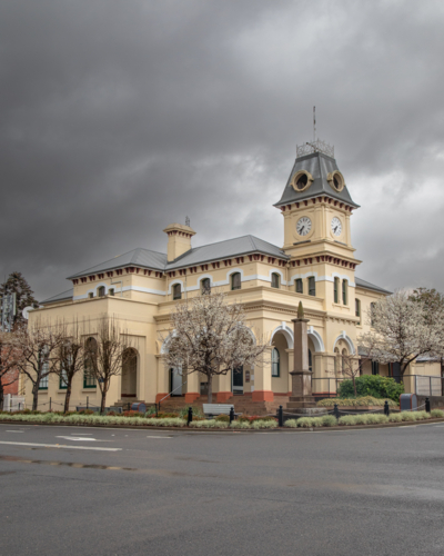 A small town country Post Office building under a stormy grey sky - Australian Stock Image