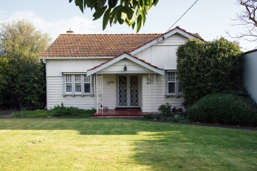 A small, white, old weatherboard house - Australian Stock Image