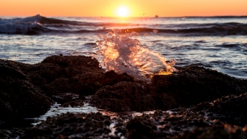 A sunlit wave splatter looking like a butterfly - Australian Stock Image