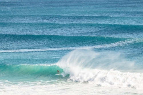 A surfer riding a long barrel wave on the Gold Coast - Australian Stock Image